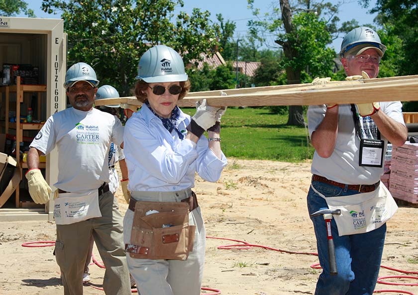 Rosalynn Carter is pictured here carrying a truss.
